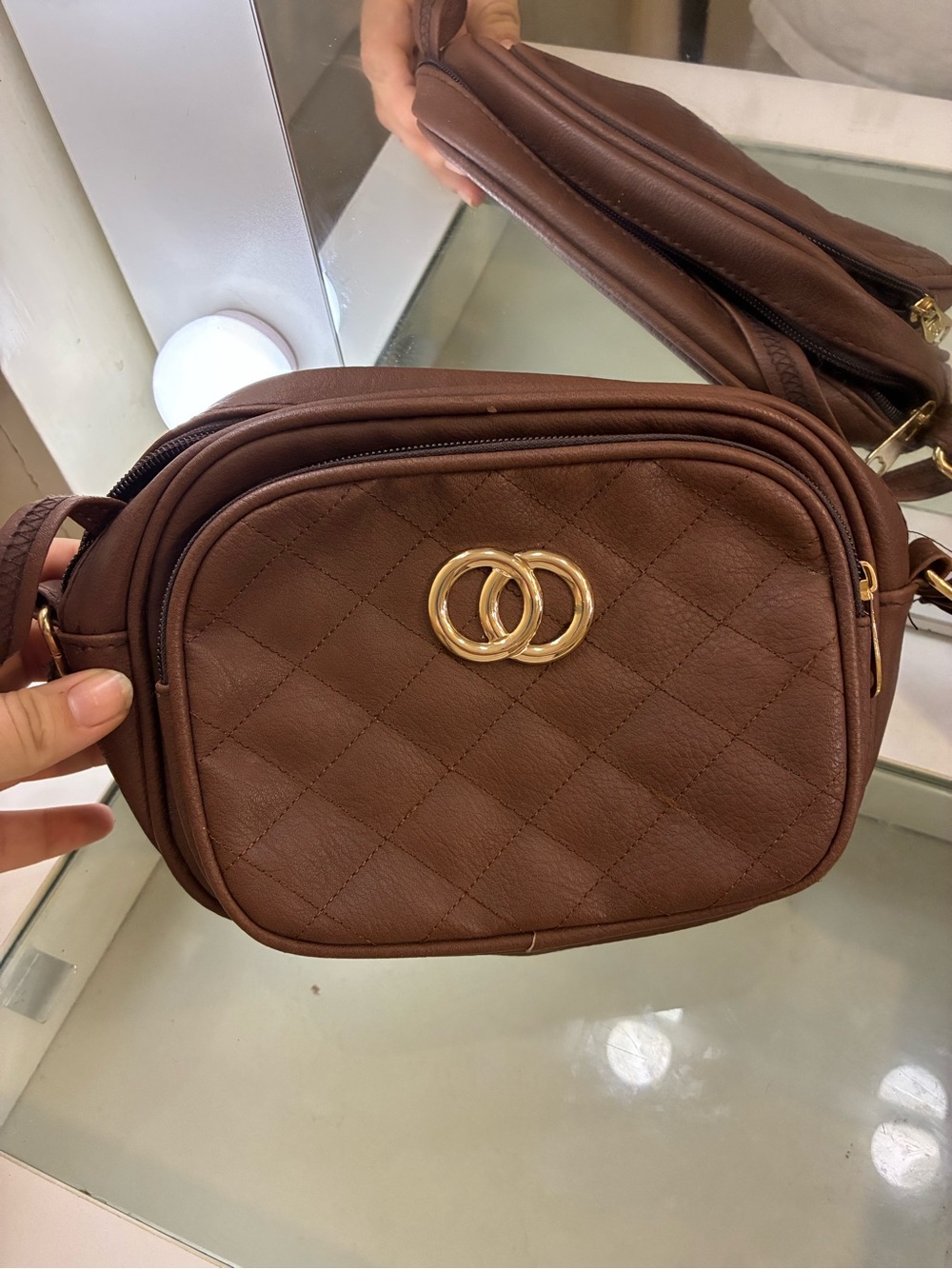 Brown crossbody with quilted design and gold hardware